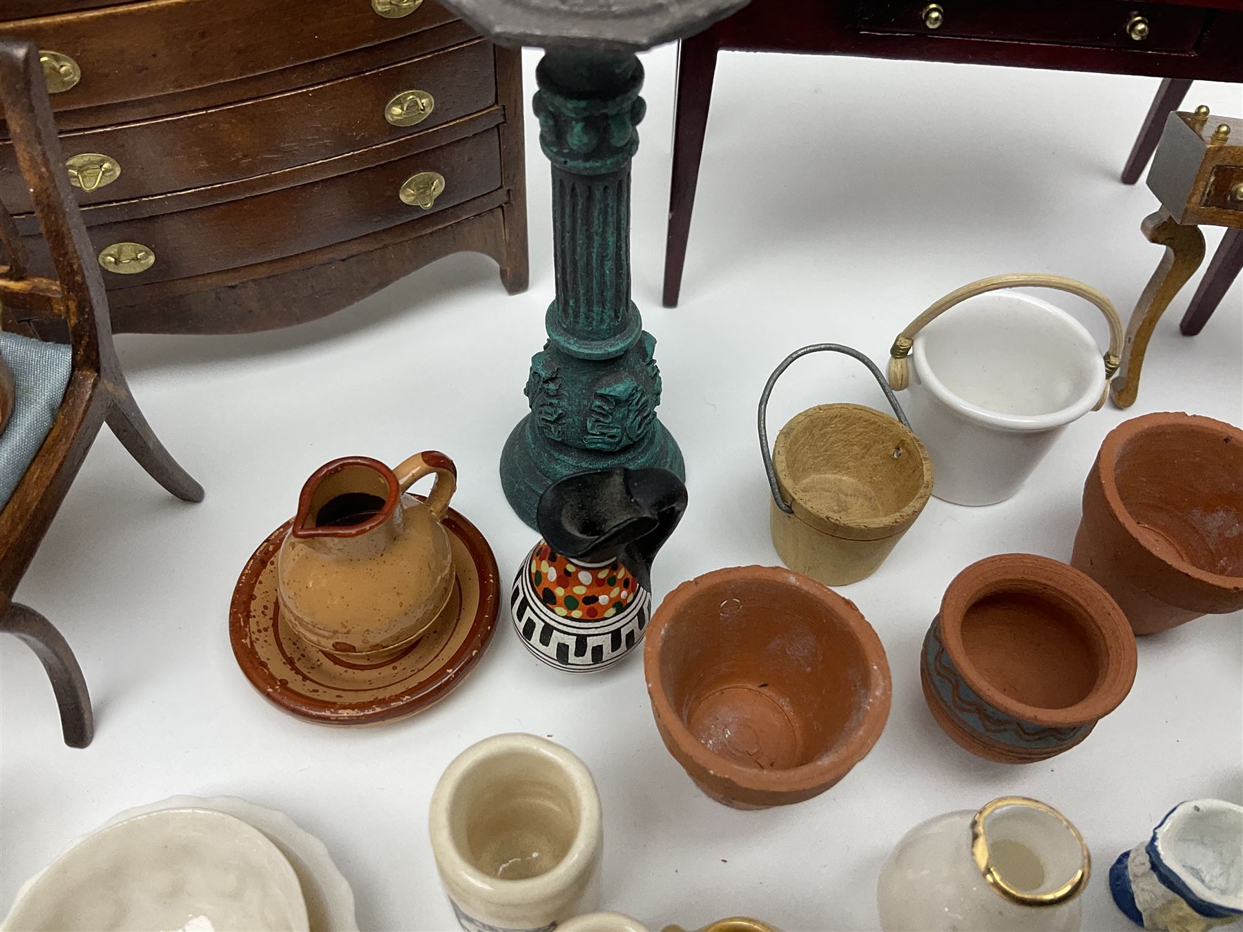 Collection of miniature dolls house furniture and accessories, to include long case clock, chest of drawers, tiled wash stand, ceramics and glass ware, mirror, baskets, etc 