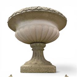 Pair of weathered cast stone Neoclassical design garden Kylix shape urns, foliate moulded rim over a gadrooned underbelly, the scalloped socle over a rectangular pedestal with faux-panelled sides, stamped with stylised ‘H’ monogram