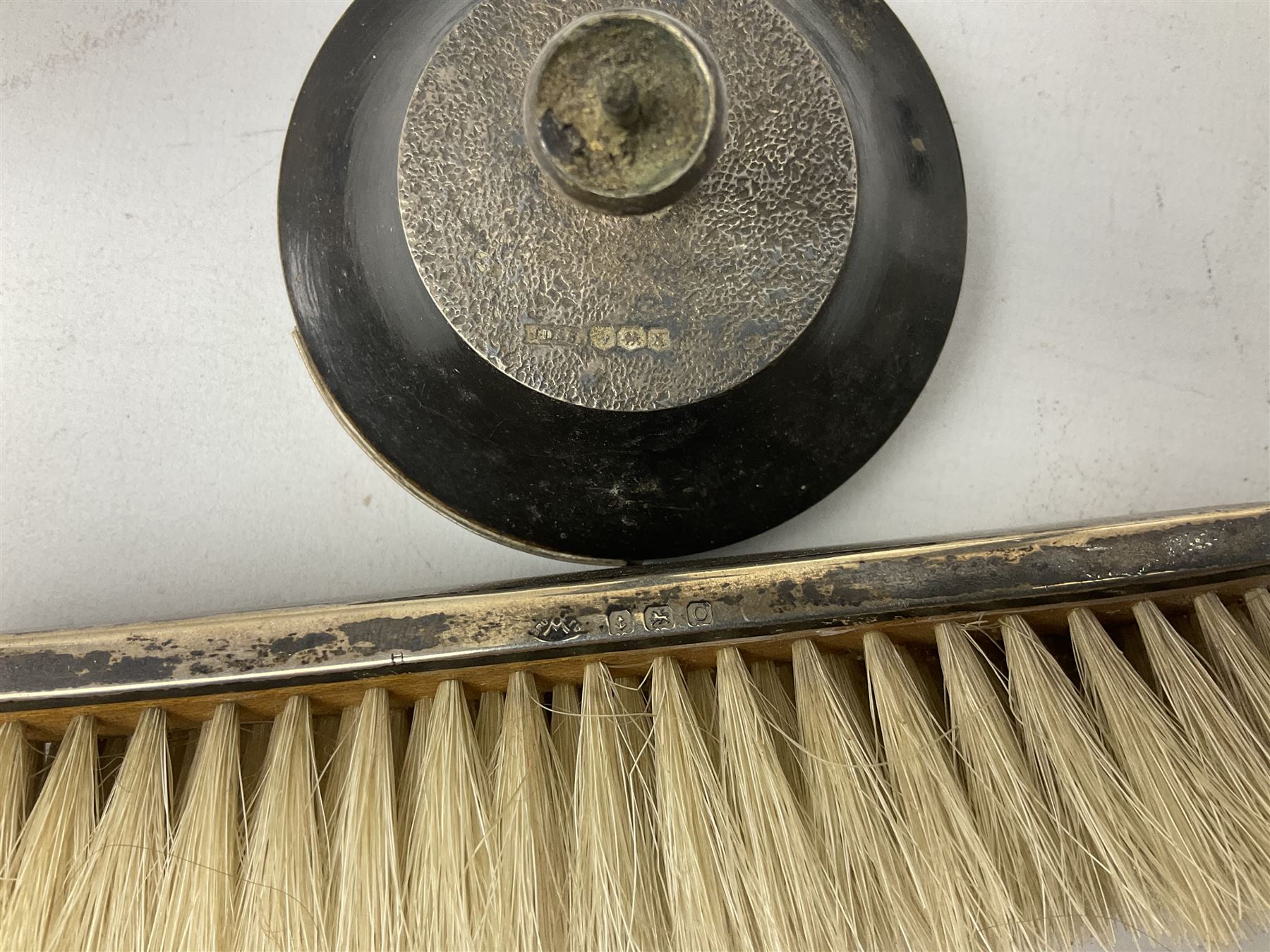 Two early 20th century silver trumpet vases to include a Martin Hall & Co Ltd example, silver circular box raised on three feet stamped Birmingham 1912, ashtray hallmarked London 1945, silver backed hair brush with engine turned decoration etc, tallest H19.5cm