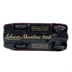 Schuco Akustico 2002 tinplate clockwork car, in burgundy with green metallic interior, with key