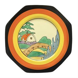 Clarice Cliff Bizarre for Newport Pottery Orange Roof Cottage pattern plate, circa 1932, hand painted with a stylised cottage and bridge landscape with yellow, orange and black banding, black printed mark beneath, D22cm 