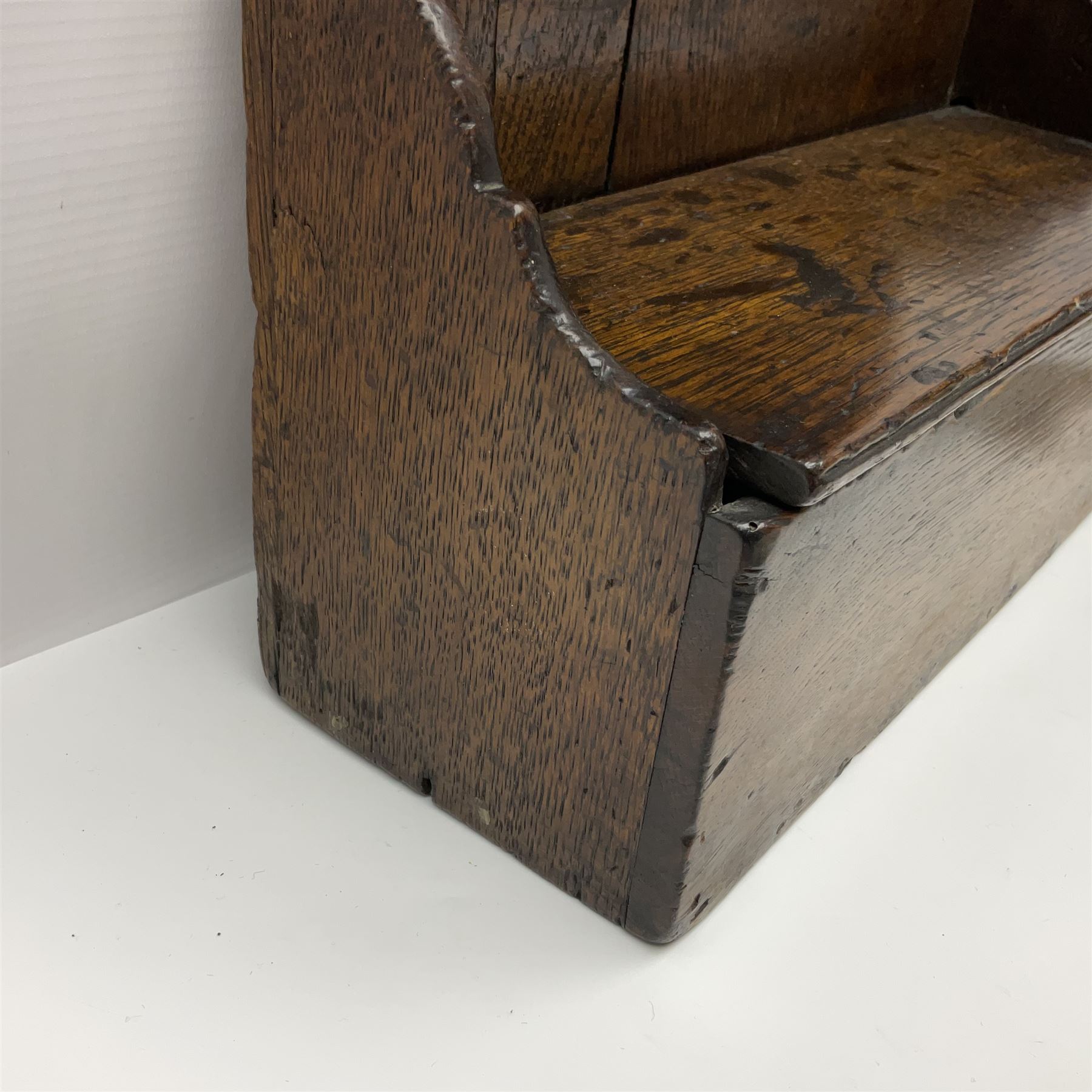 George III oak spoon rack and candle box, the rectangular backplate with shaped  pediment and two six aperture spoon racks, above a candlebox with hinged cover, with various brass spoons and a pair of brass candle snuffers, H56.5cm, W35cm, D14cm 