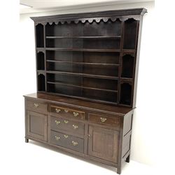 George III oak dresser raised three tier plate rack, projecting cornice, dentil frieze, five drawers and two cupboards, stile supports 
