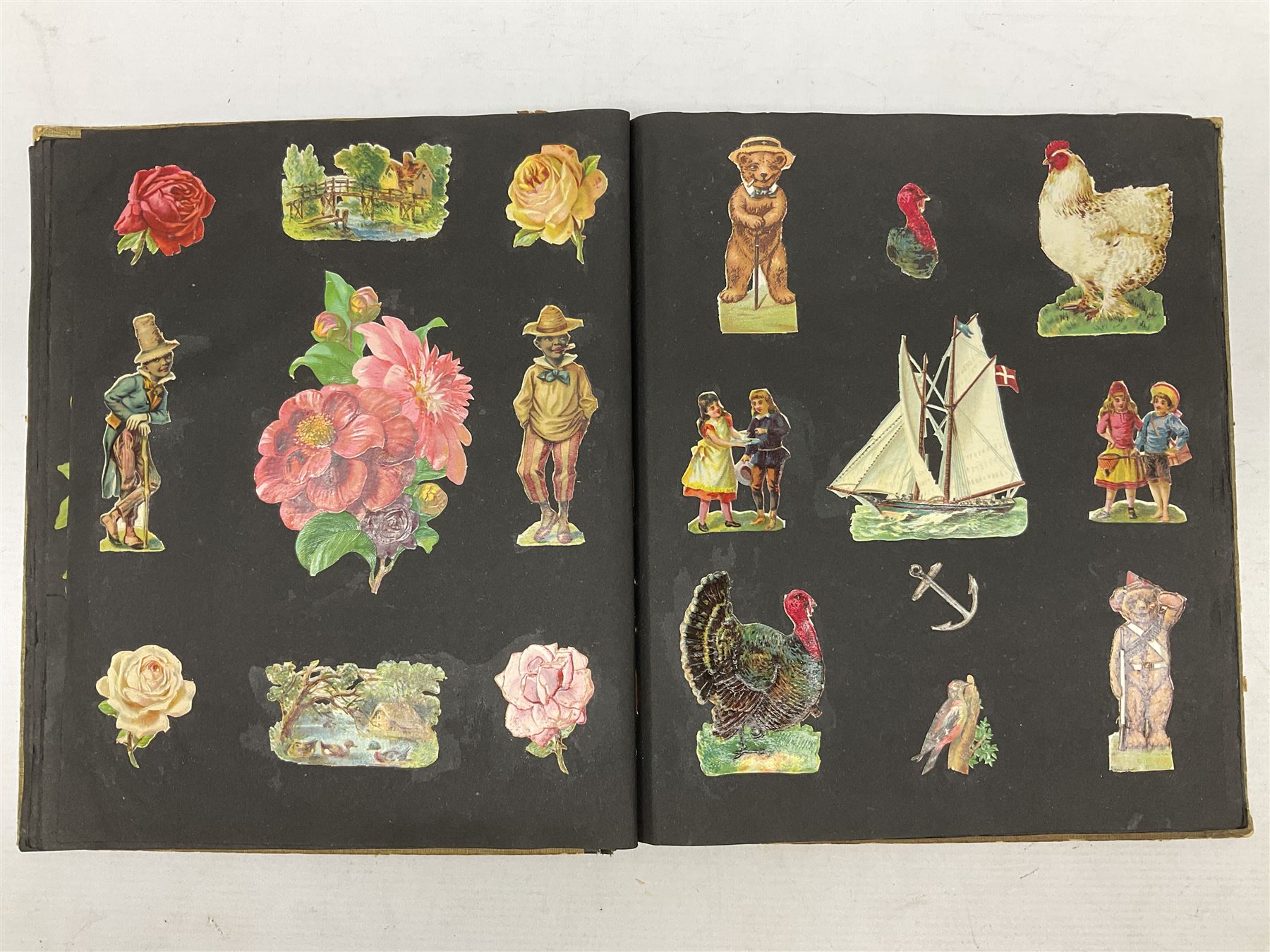 Victorian scrapbook containing twenty-six double sided pages and two fixed end pages of various fixed decoupage to include clippings of maritime interest, greeting cards, portraiture, flowers, animals etc, 