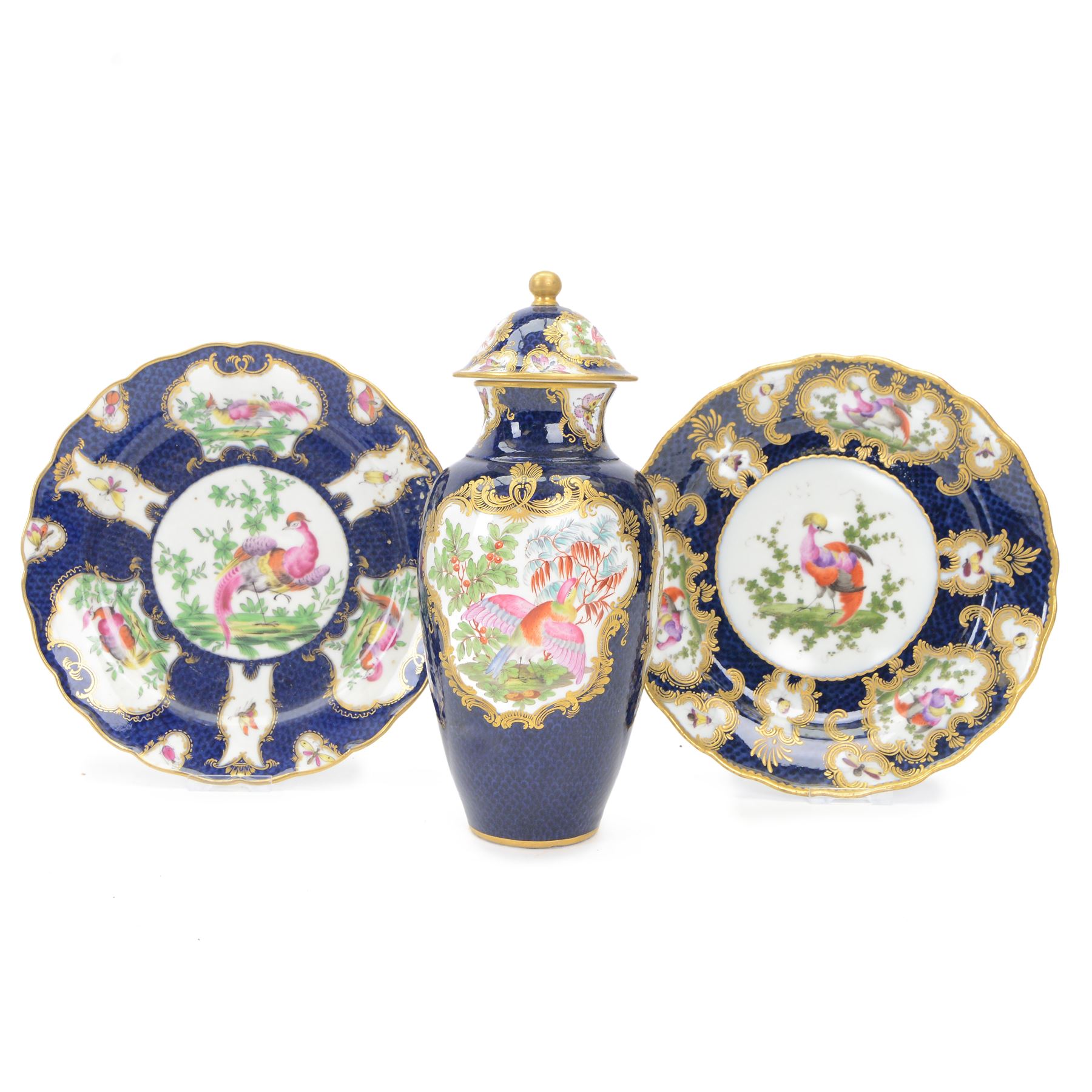 Late 19th/early 20th century Samson, Paris porcelain vase and cover, of baluster form, decorated after Worcester with gilt C scroll surround reserves painted with exotic birds, and insects and butterflies, upon a blue scale ground, H25cm, together two similarly decorated late 19th/early 20th century Samson, Paris cabinet plates, one example with spurious fret mark beneath, D22cm
