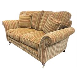 Parker Knoll - two seat sofa upholstered in pale striped fabric (W178cm), and matching armchair upholstered in pale dotted fabric (W95cm), on turned front feet with brass cups and castors 