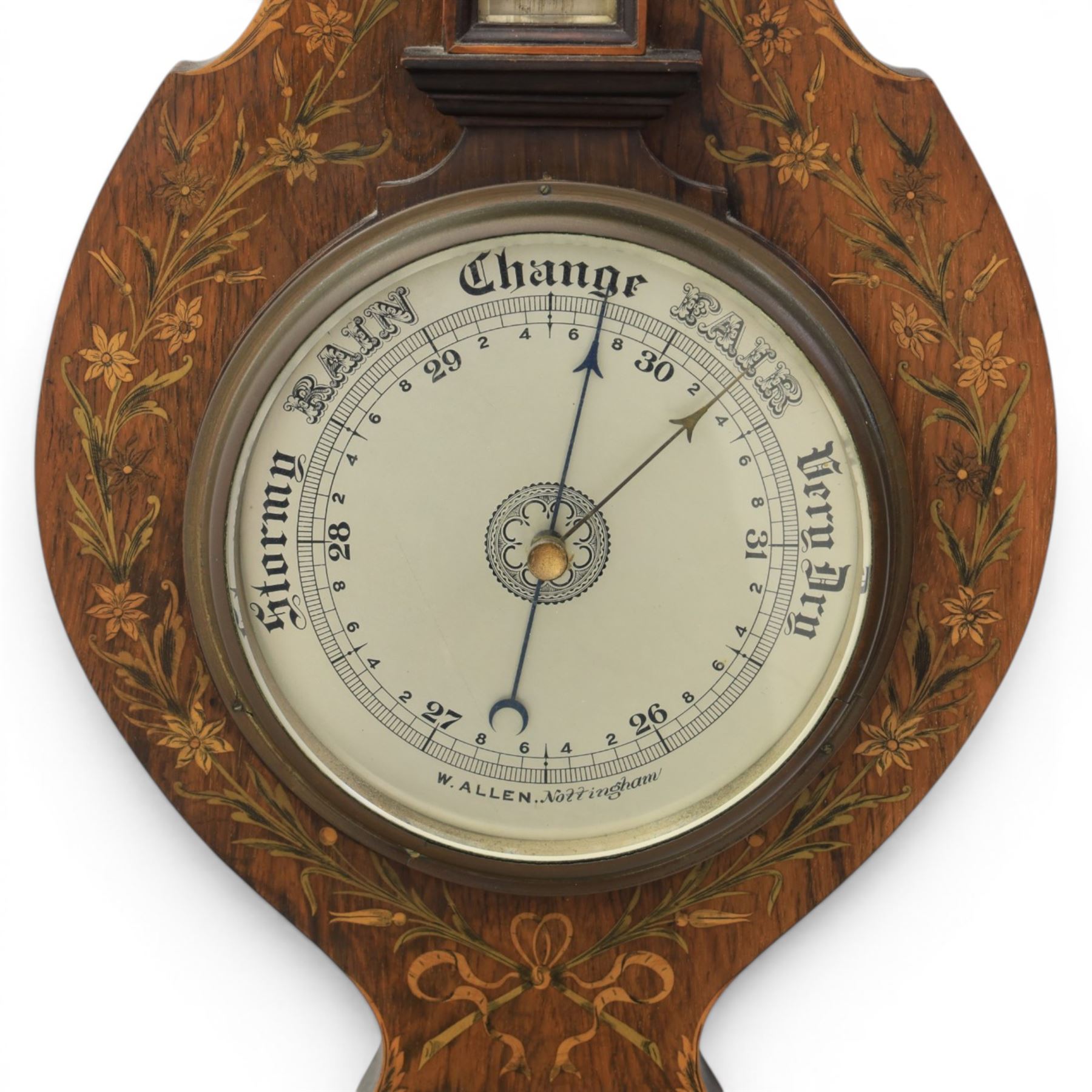Edwardian mahogany barometer, shaped case with swan neck pediment and urn finial, satinwood inlaid floral and ribbon tied decoration, fitted with silvered thermometer scale over circular aneroid dial, signed W. Allen, Nottingham