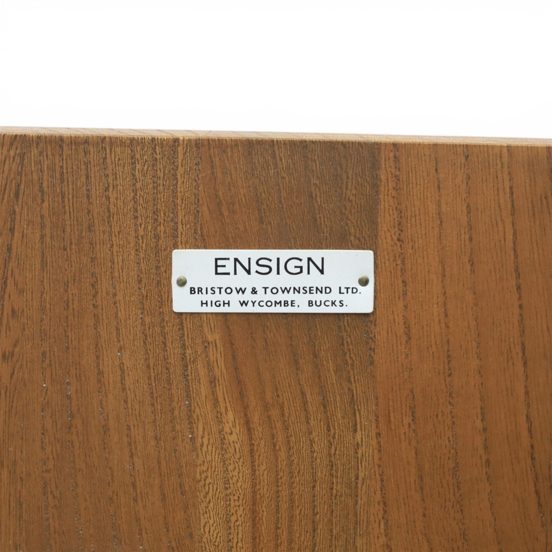 Ensign - Mid-20th century elm sideboard, with a central bank of four drawers, flanked by cupboard doors, raised on tapering supports, labelled Ensign Bristow & Townsend Ltd