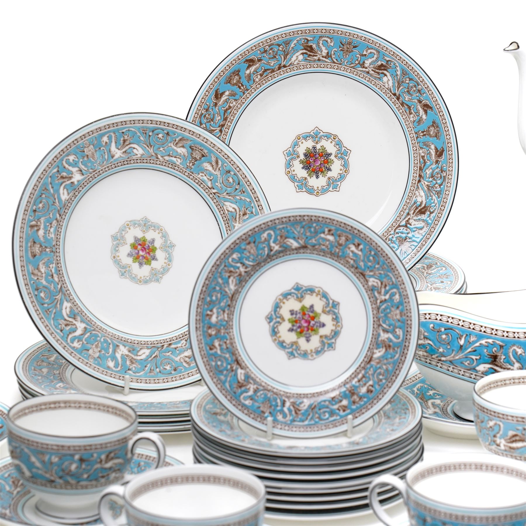Wedgwood turquoise Florentine part service, comprising large covered tureen and stand, coffee pot, teapot, two covered sucriers, milk jug, two sauce boats and stands, seven soup plates, three bowls, jug, eighteen soup bowls and fifteen stands, two ashtrays, thirteen further saucers, twelve teacups and eleven saucers, and twenty-one further plates of varying sizes
