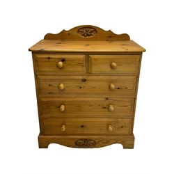 Pine chest of drawers topped with carved pediment with acorn and oak leaf motif, fitted with two short over three long drawers, standing on shaped apron base (W92, D46, H97cm); pine bedside cabinet, single drawer above paneled cupboard door enclosing open storage, shaped plinth base (W43, L32, H67cm)