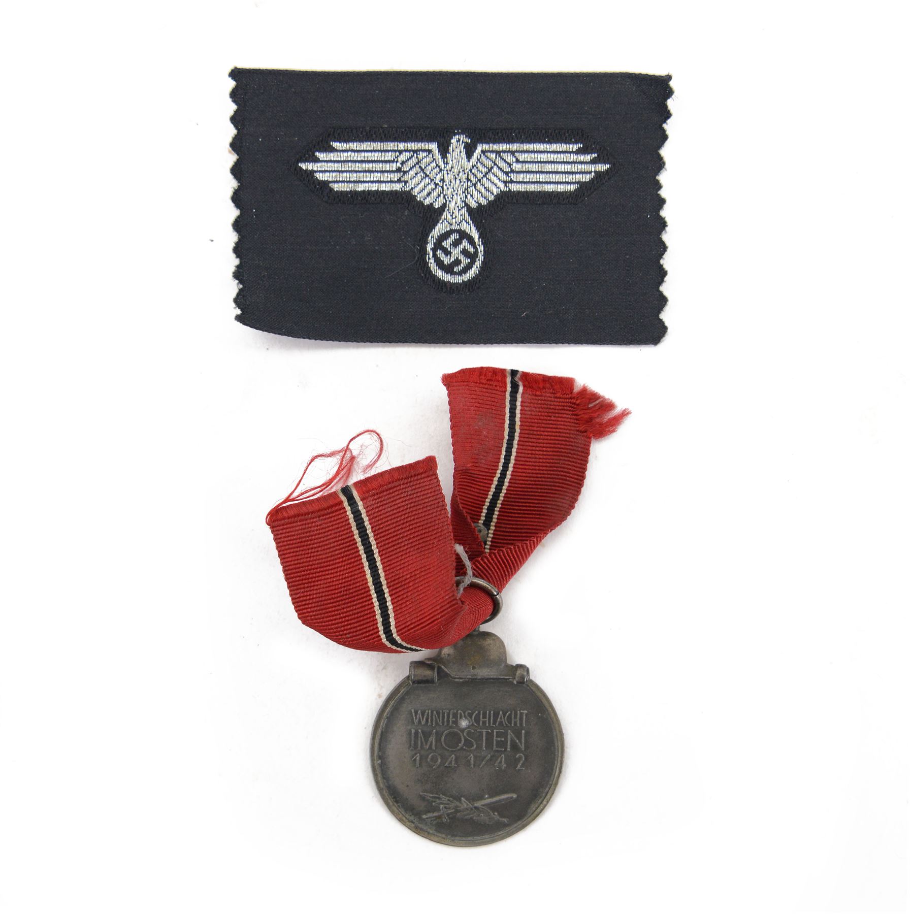 Third Reich SS officers cap insignia, machine-woven silver bullion SS Eagle, on black rectangle, together with German Eastern Front Medal, insignia H5cm, L7cm 