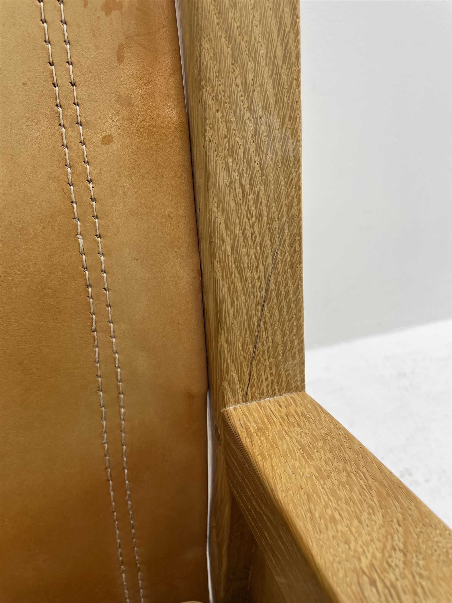 'Mouseman' oak smokers armchair, panelled sides, slung tan leather back and upholstered seat cushion, by Robert Thompson of Kilburn