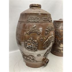 Two 19th century brown salt glazed stoneware spirit barrels, decorated in relief with the royal coat of arms, largest H58cm