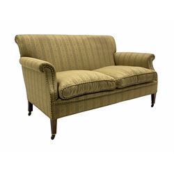 Early 20th century beech framed settee upholstered in a foliate striped fabric, sprung seat and back, square tapering front supports with brass and ceramic castors