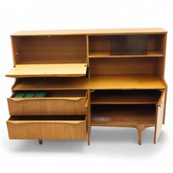 Sutcliffe of Todmorden - Mid 20th century teak highboard, ‘S-Form’ range, the upper section with glazed and panelled sliding doors above open shelving, over a base fitted with twin drawers and cupboards, all with moulded recessed handles, on shaped tapering supports, reflecting the sleek organic styling characteristic of 1960s British modern furniture design