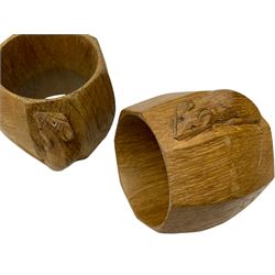 Mouseman - pair oak napkin rings, faceted bulbous form carved with mouse signature, by the workshop of Robert Thompson, Kilburn, H5cm 
