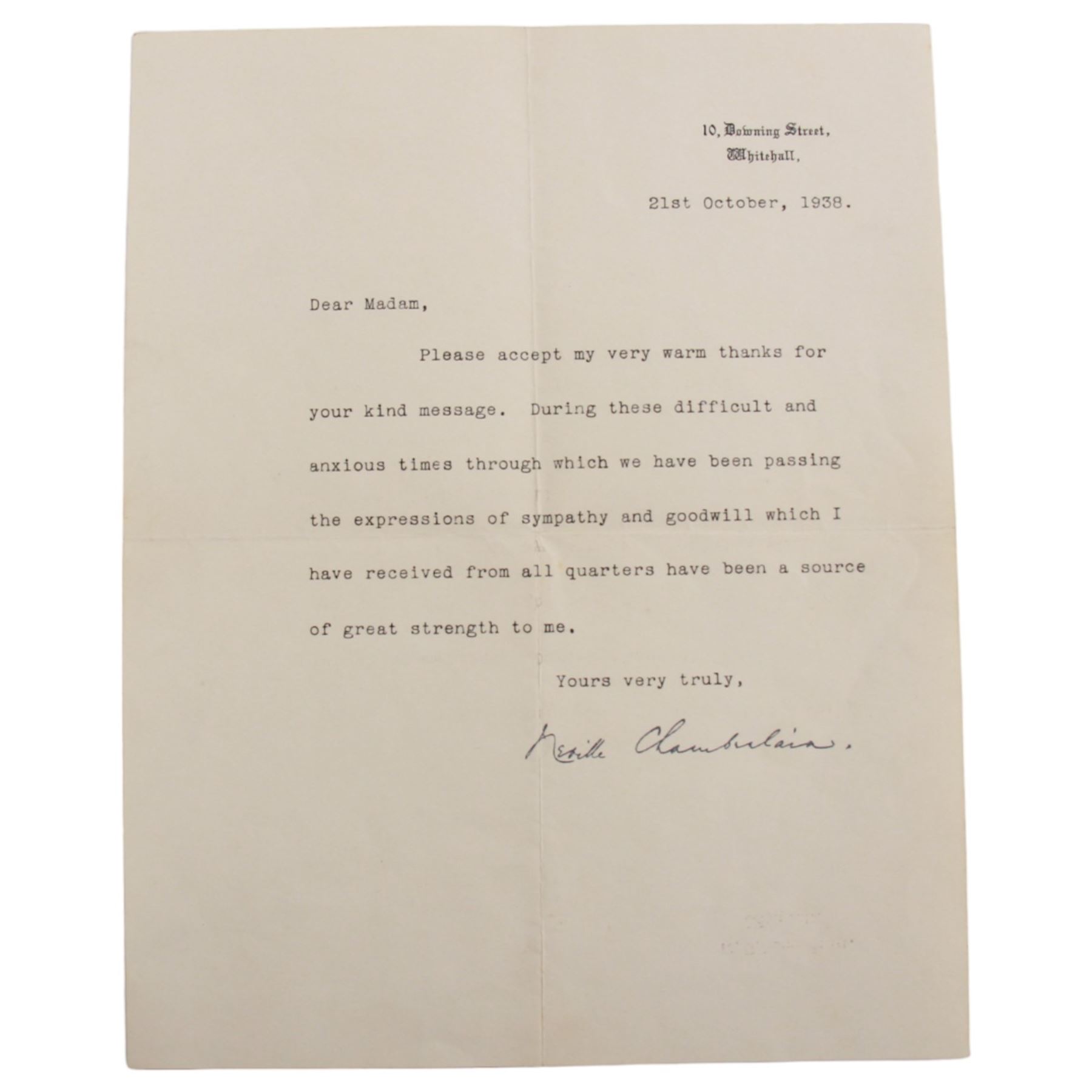 Neville Chamberlain (British Prime Minister 1937-1940) - typed letter signed by Neville Chamberlain dated 1938, reading 'Dear Madam, Please accept my very warm thanks for your kind message. During these difficult and anxious times through which we have been passing the expressions of sympathy and goodwill which I have received from all quarters have been a source of great strength to me, yours very truly', together with a 1935 jubilee Buckingham Palace cake box, with cake remnants 