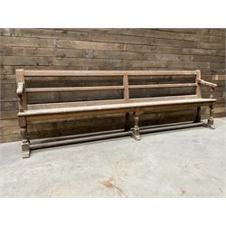 Victorian pitch pine bench pew, turned arms and legs, rail back with plank seat, 274cm