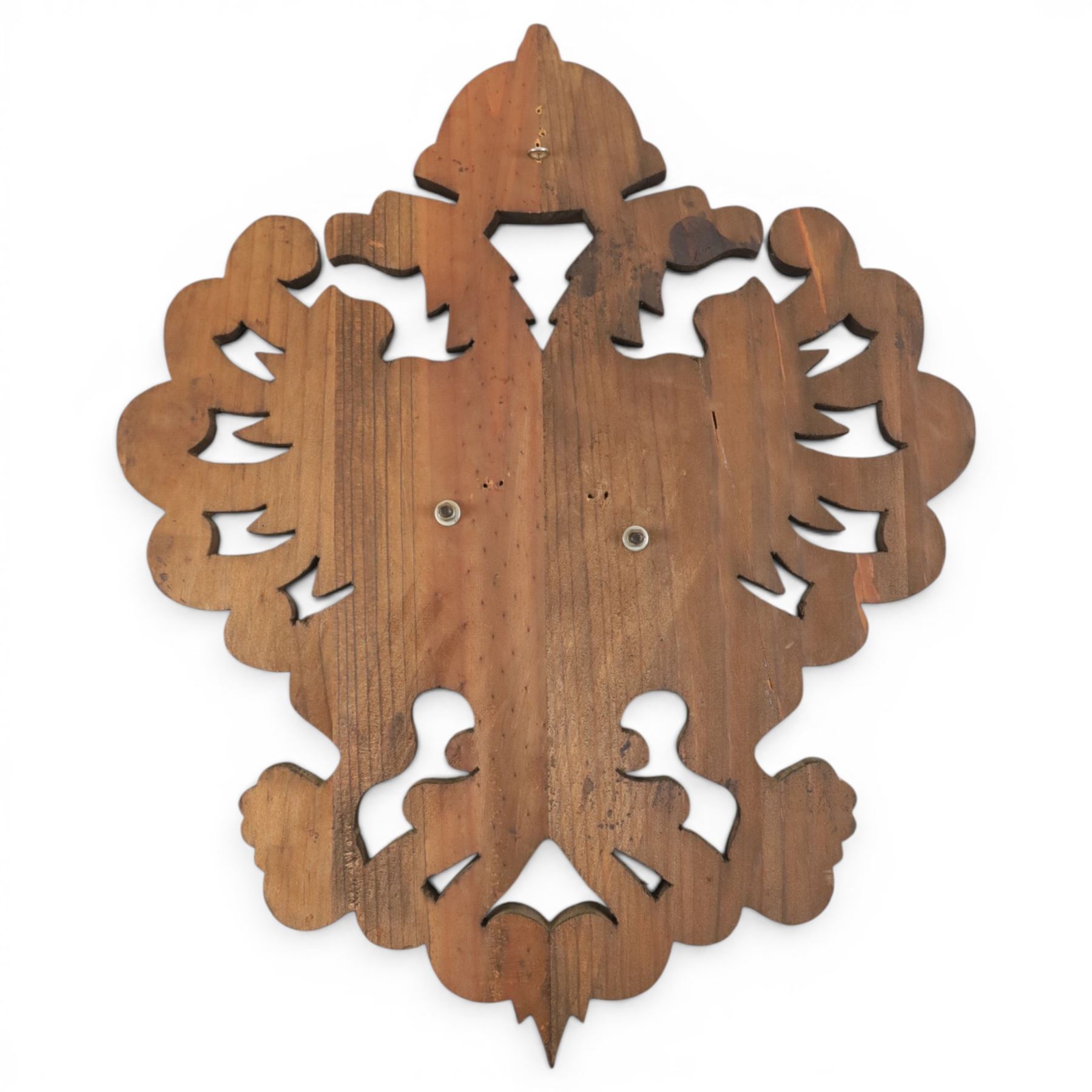 Carved wooden wall plaque, decorated with foliate scrolls, with two reproduction swords attached, together with five other wooden plaques with foliate scrolls and shields