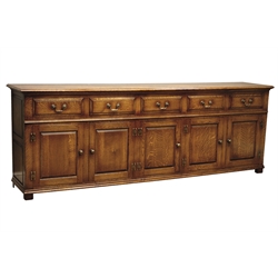  18th century style oak low dresser, with moulded top above five fielded front drawers and five raised and fielded panel doors with brass H shaped handles, on stile feet, W245cm, H87cm, D46cm  