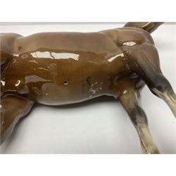 Four Beswick horse figures, comprising Quarter Horse, two Shires no 818 and matt palomino, together with Beswick donkey and Royal Doulton horse on a wooden plinth  