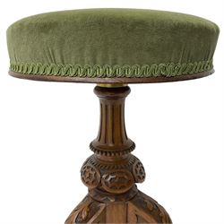 Late Victorian walnut piano stool, circular upholstered revolving seat, on fluted and carved column, three splayed supports carved with foliage and scrolls 