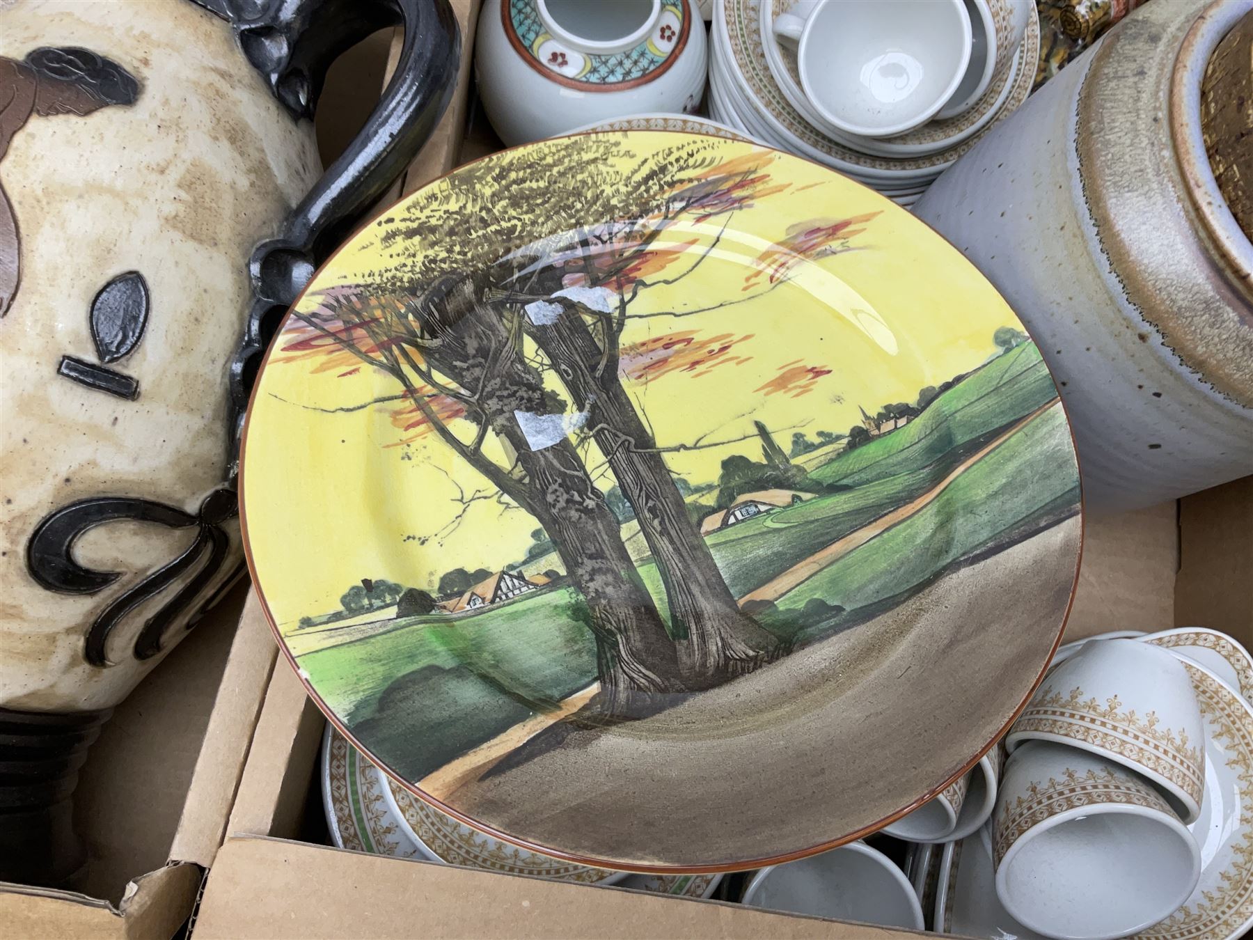 Set of three graduating stoneware jars with cork lids, indistinctly