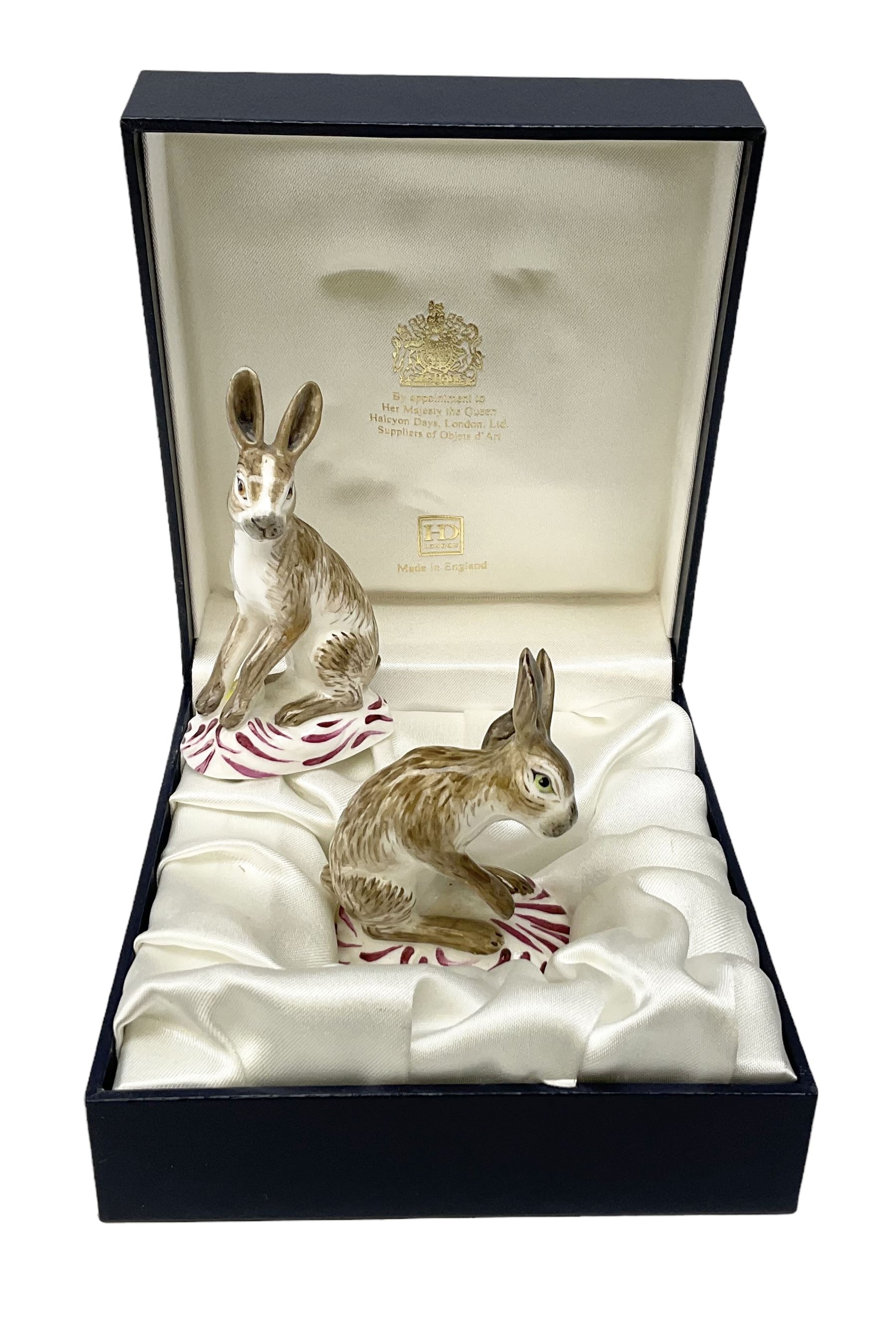 Two Halcyon Days porcelain figures of hares, inspired by Bow porcelain hare c1755, in box 