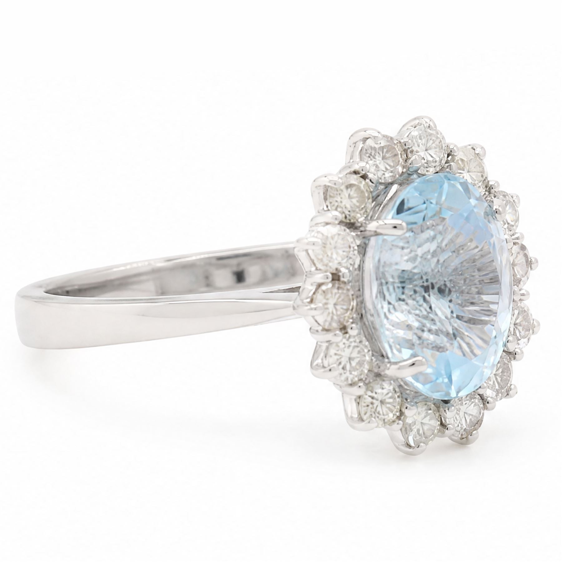 18ct white gold aquamarine and diamond cluster ring, single oval cut aquamarine of approx 2.80 carat, surrounded by fourteen round brilliant cut diamonds, hallmarked, total diamond weight approx 0.60 carat