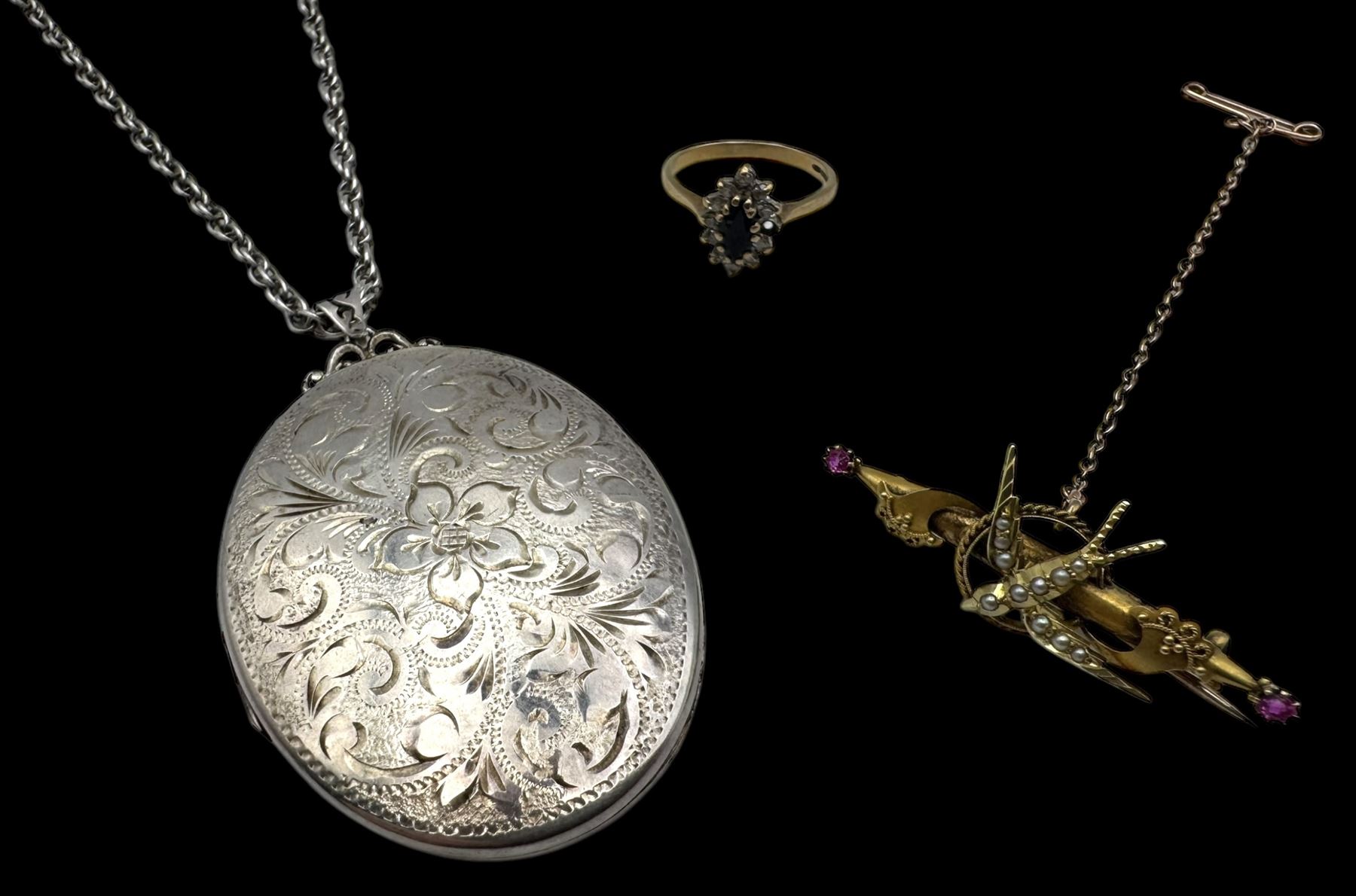 15ct gold swallow brooch, 9ct gold stone set cluster ring and a silver locket pendant, all hallmarked 