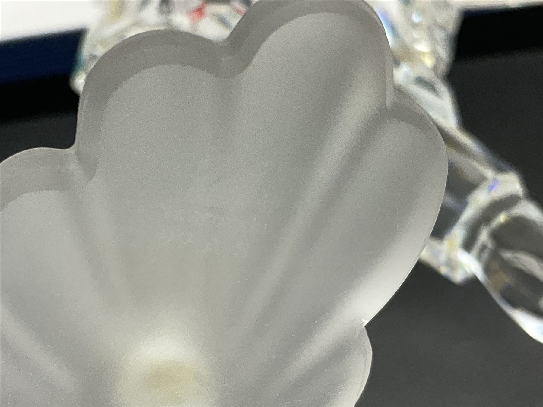 Swarovski Crystal Masquerade trilogy; 1999 Masquerade Pierrot, 2000 Columbine, 2001 Harlequin all with accompanying plaque, stand and original box, together with a glass display case with mirrored back and sides 