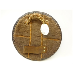  Replica Scottish Highlander's Targe by Joe Lindsay, based on an original targe depicted in 'Drummonds Ancient Scottish Weapons' and in the 19th century belonged to Keith Stewart Mackenzie of Seaforth, the wooden shield covered in tooled leather with traditional Celtic designs, brass studs and mounts with deer skin hide verso, D49cm   