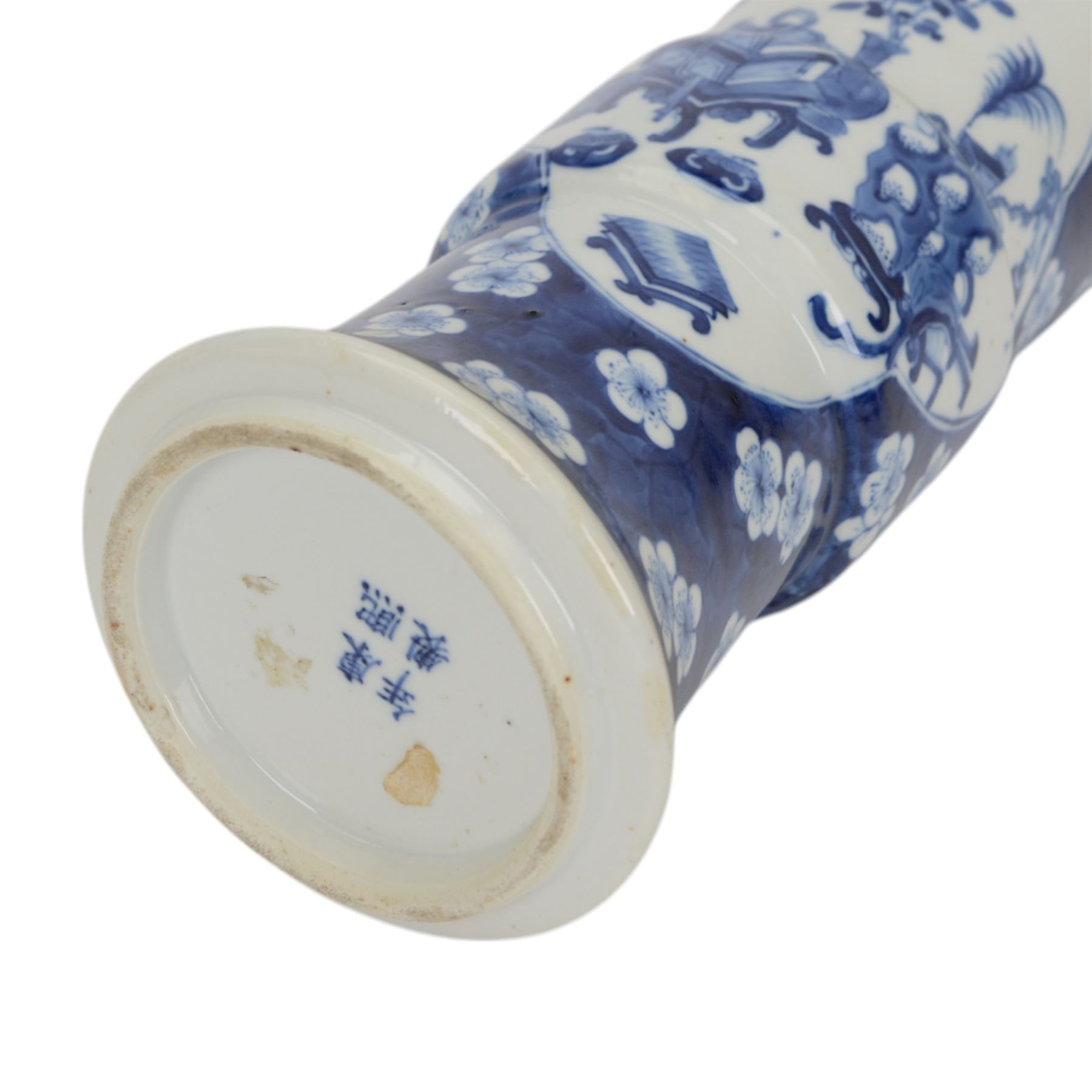 Late 19th century Chinese blue and white gu beaker vase, decorated with two lobed reserves containing precious objects, against a prunus and cracked ice ground, with apocryphal Kangxi mark beneath, H30.5cm