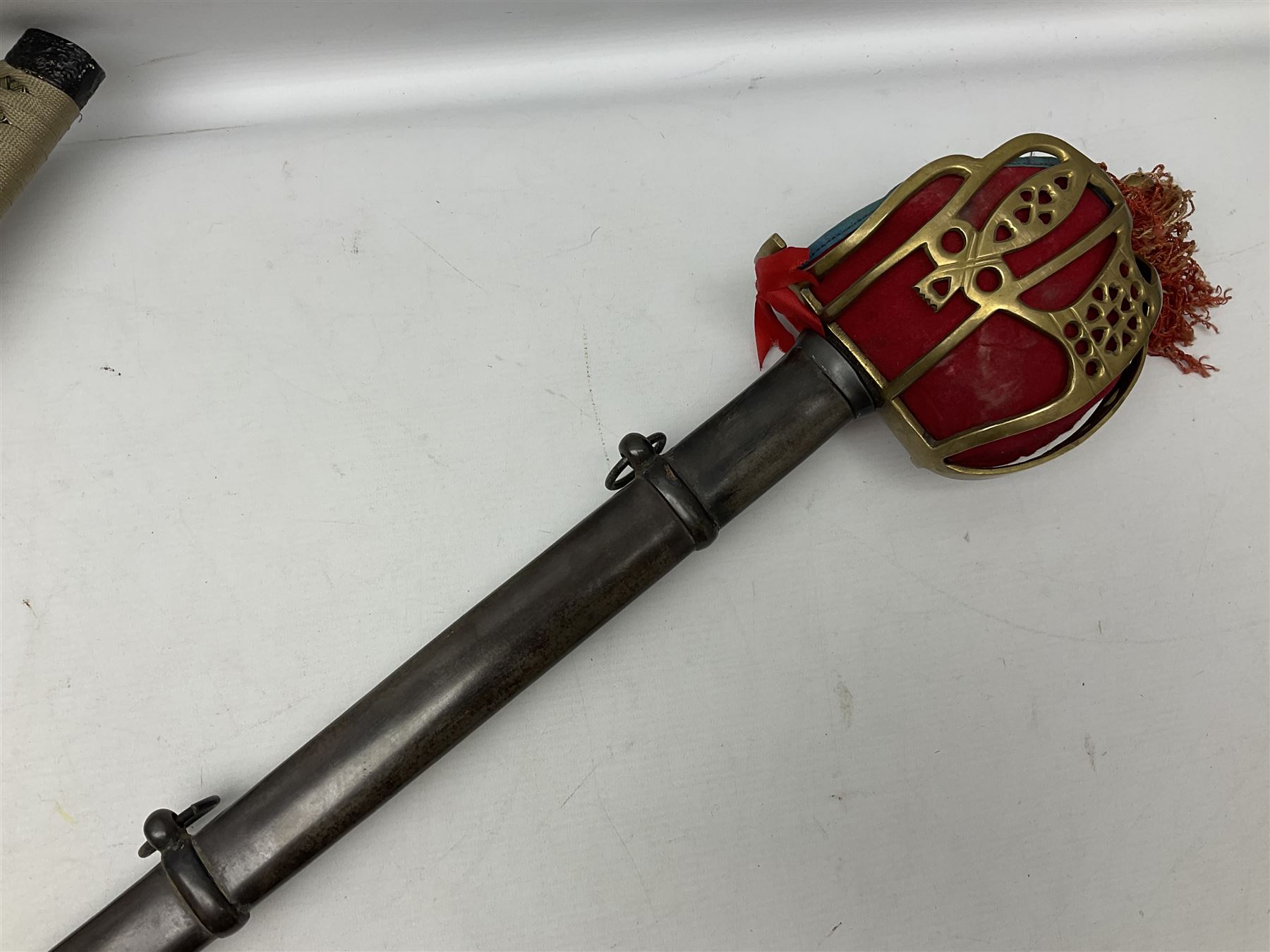 Reproduction Scottish officers basket hilt broad sword, the brass basket pierced with heart-shaped motifs lined with red lining, together with a reproduction Japanese Katana sword, longest L110cm