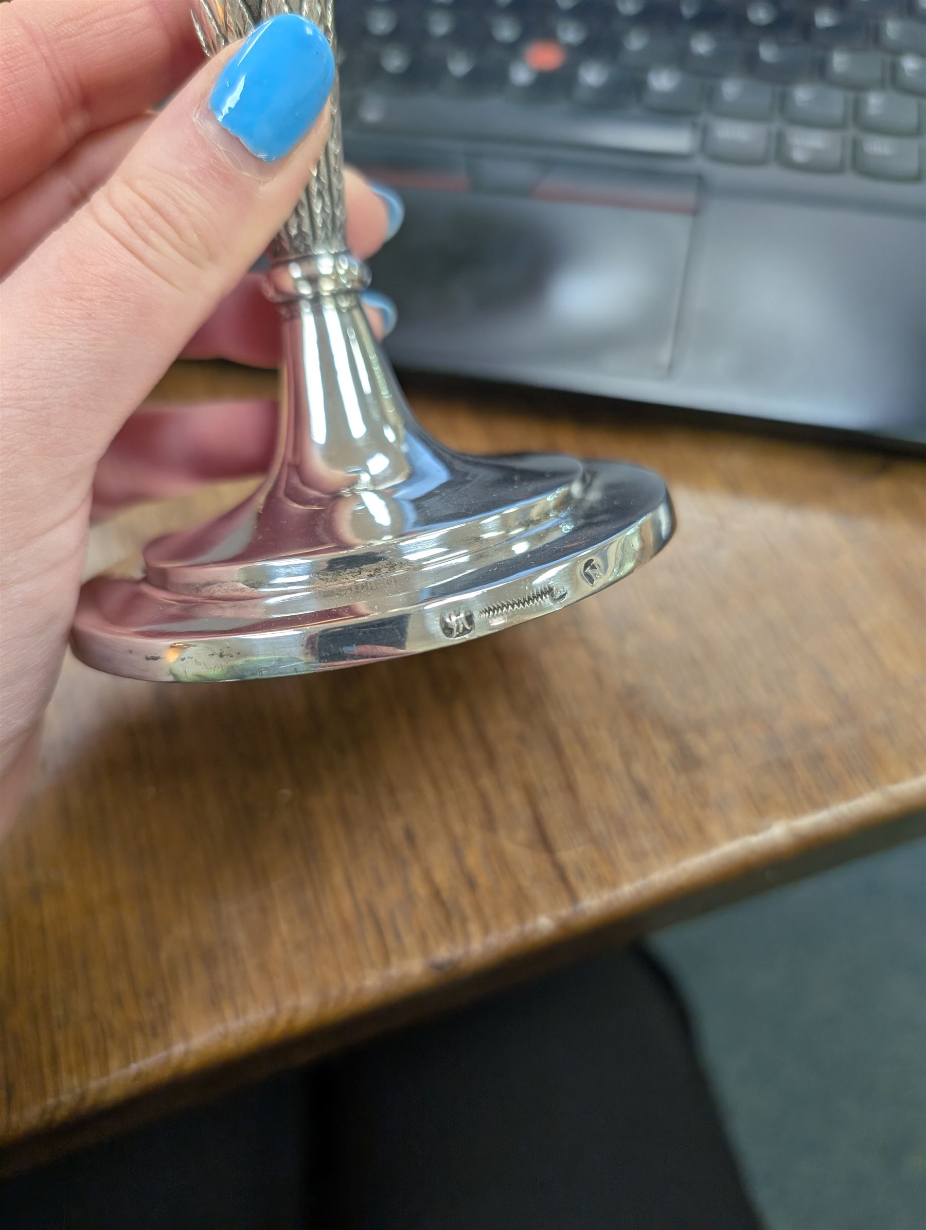 Pair of continental silver candlesticks, probably German Hanau, each of tapering form, with fern leaf decoration, upon a stepped circular base, with Hanau marks and assay scrape to base, H19cm