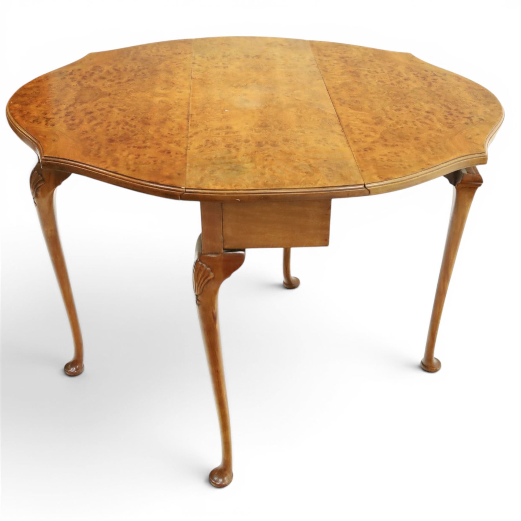 Queen Anne design walnut drop-leaf table, figured top with serpentine drop leaves, shell carved knees on cabriole supports