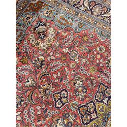 Persian Kashan peach ground rug, central rosette medallion surrounded by trailing branches and flower heads with bird motifs, light blue spandrels with further floral decoration, the main border with repeating palmettes and birds, within guard stripes