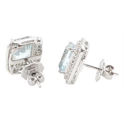 Pair of 18ct white gold aquamarine and diamond cluster earrings, each stud set with a single octagonal cut aquamarine and two rows of round brilliant cut diamonds, total aquamarine weight approx 6.30 carat, total diamond weight approx 1.00 carat