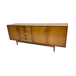 Kofod Larsen for G-Plan - mid-20th century teak sideboard, fitted with four graduating drawers flanked by single and double cupboard enclosing shelves, each with square wooden handles, raised on tapering feet