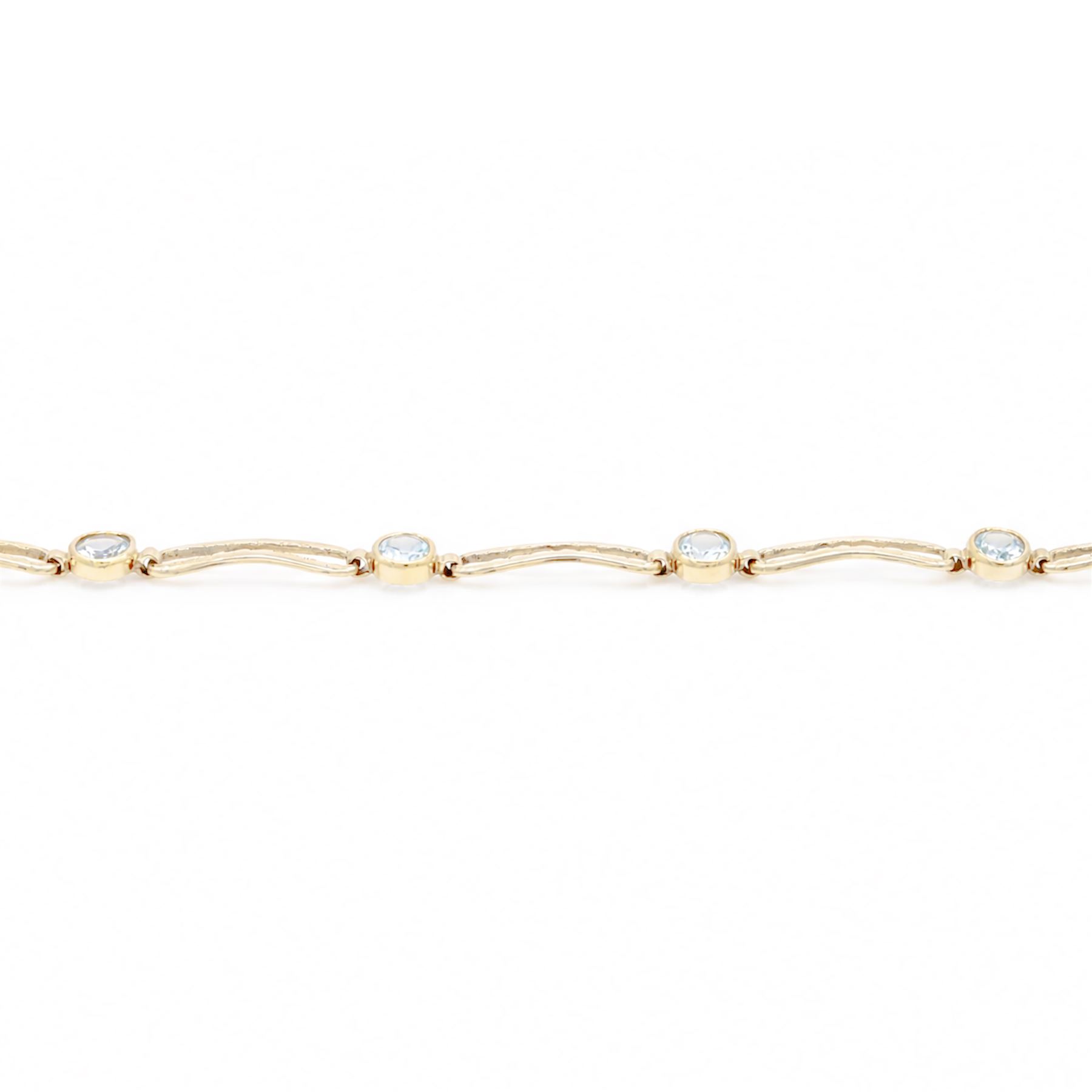 Gold blue topaz bracelet, bezel set with five oval cut topaz's, each spaced by fancy rectangular links, stamped 9ct