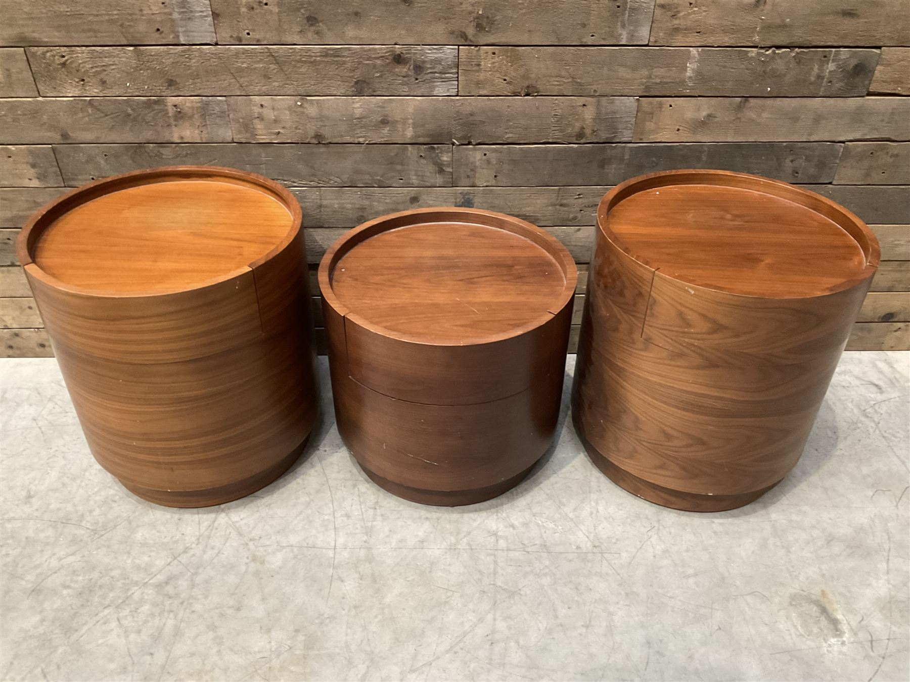 Three walnut circular barrel shaped lamp tables, fitted with single drawer (lower table D53cm, H49cm)