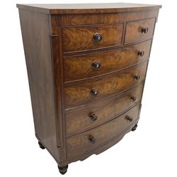 Tall Victorian mahogany bow-front chest, fitted with two short over four long cock-beaded drawers, with turned handles, canted upright corners with quarter columns, shaped apron, on turned feet