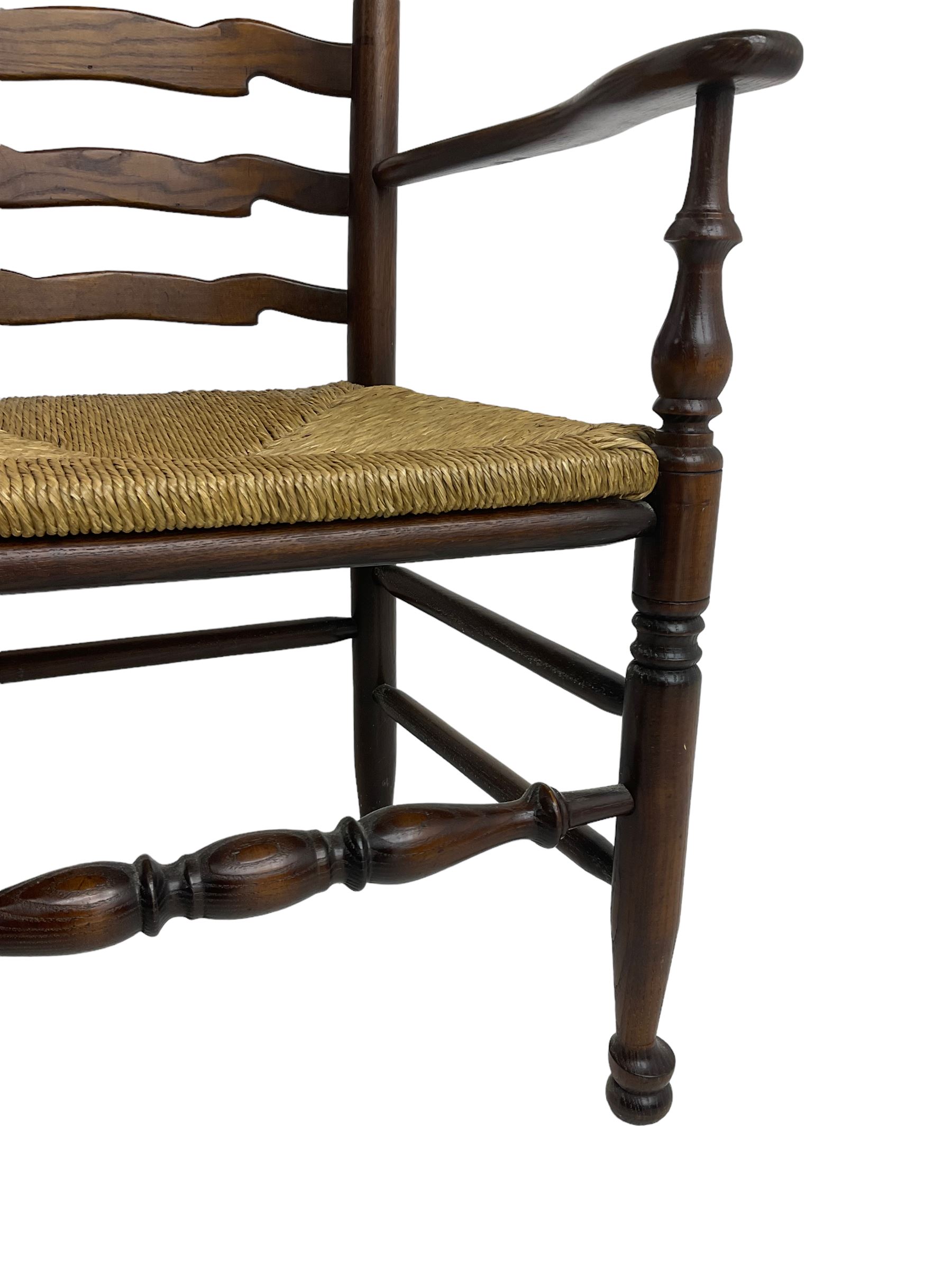 Set eight (6+2) oak dining chairs, high waived ladder back over rush seats, raised on ring turned supports with pad front feet, united by stretchers