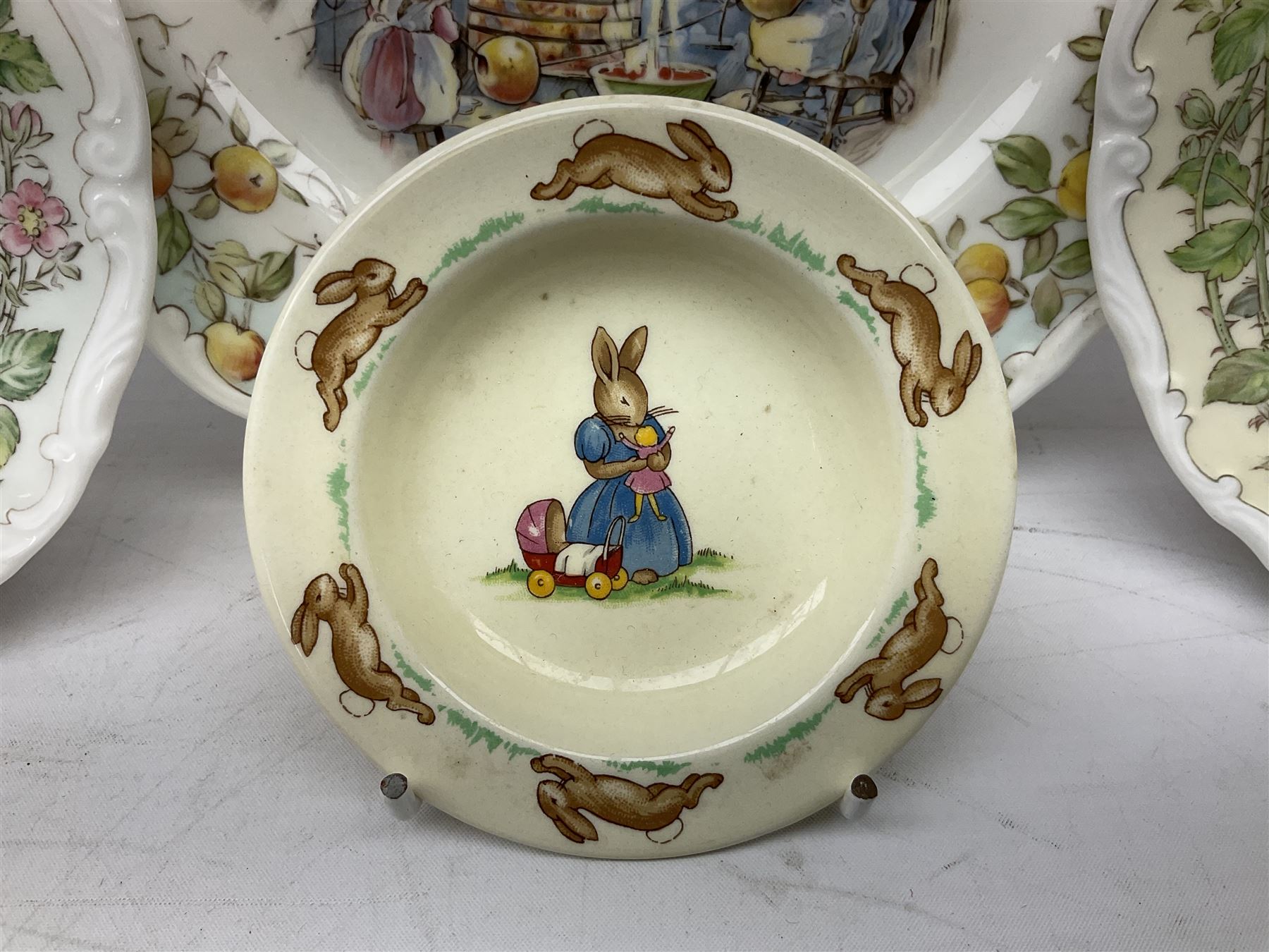 Royal Doulton Brambly Hedge plates comprising Crabapple Cottage, Spring and Summer, together with Royal Doulton Bunnykins nursery plate, bowl, cup etc