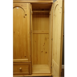 Waxed pine triple wardrobe, enclosed by three stepped arch panelled doors, three drawers, W164cm, H202cm, D65cm  