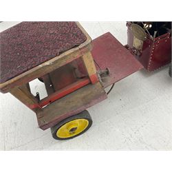 Scratch-built red and yellow painted live-steam scale model of a Showman's Traction Engine, 'Supreme' S.A. Oates & Sons, the simulated planked wooden canopy with twisted brass supports and rope light edging, 19cm flywheel, 32cm diameter rear wheels with solid rubber tyres and 21cm diameter front wheels L102cm; together with scratch-built ride-on two-wheel trailer L58cm, Franzus step-down transformer and various brass rally plaques for 1980s/1990s