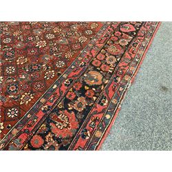 Persian Sarouk red ground rug, central medallion, reappearing field boarder 