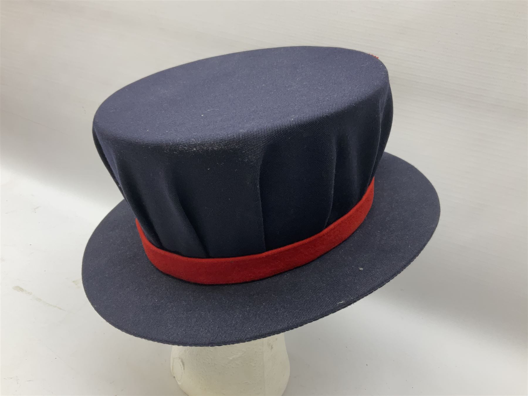 Elizabeth II Yeoman Warders (Beefeater) No.1 Undress blue uniform - comprising tunic bearing label Crown Military Uniforms H.M. Tower of London and bonnet by S. Patey (2) 