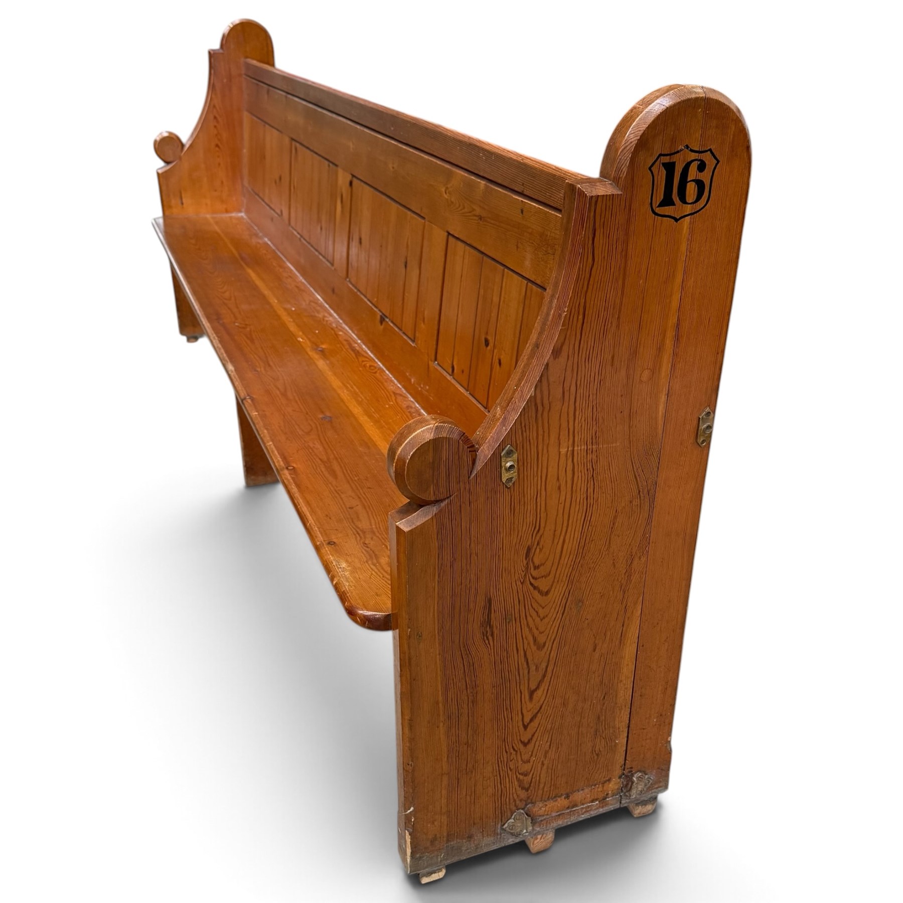 Early 20th century stained pine ecclesiastical church pew, the shaped end supports flanking slatted and panelled back, with black stencilled number '16' to the side
