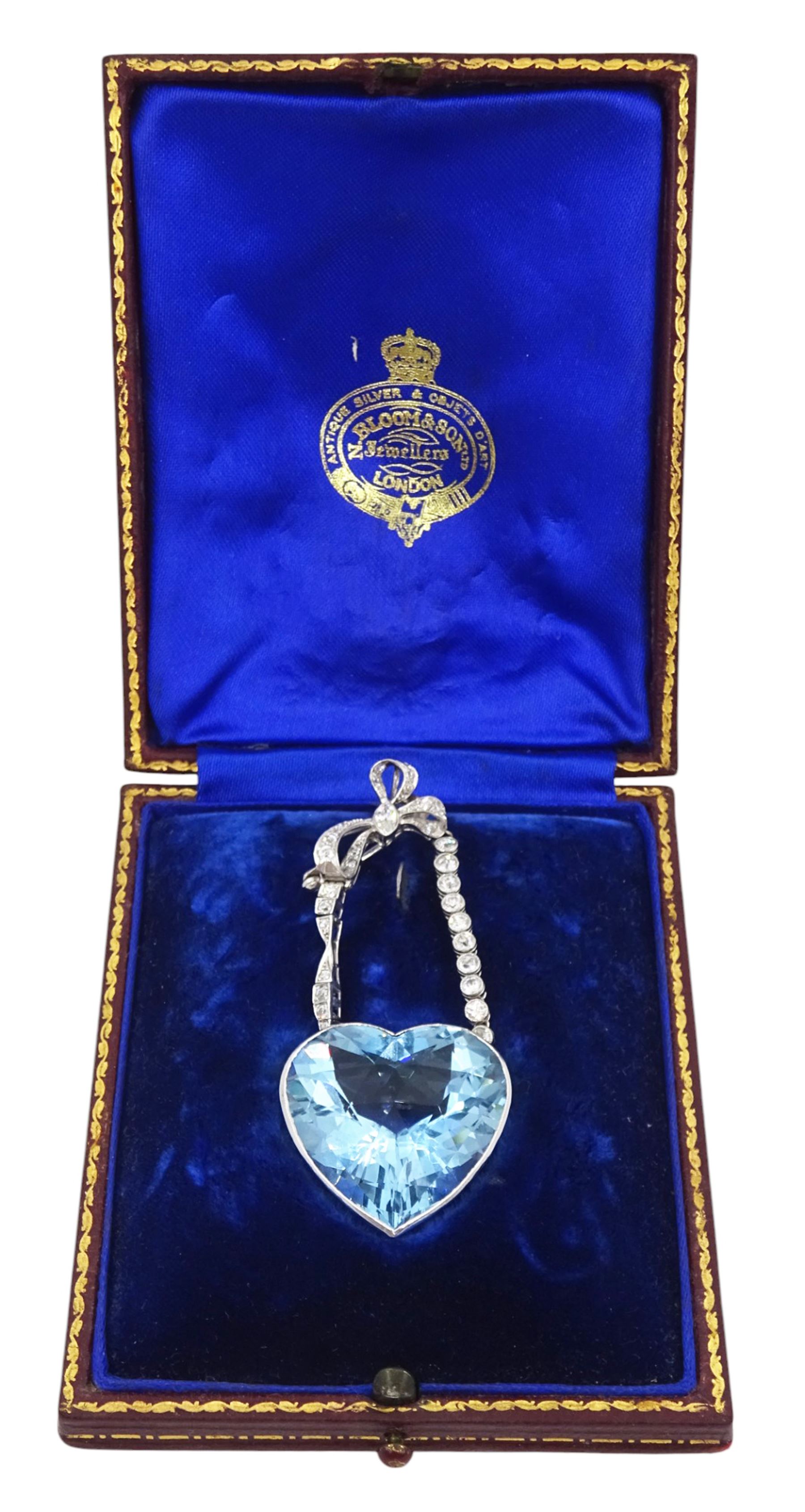 Platinum aquamarine and diamond pendant / brooch, the large faceted heart cut aquamarine, mounted within an openwork heart design gallery, suspending from a polished and milgrain set old cut diamond pendant, with bow design brooch top, set with further old cut diamonds and a single marquise cut diamond, in fitted velvet and silk lined box by Bloom & Sons, London, aquamarine approx 55.00 carat, total diamond weight approx 0.60 carat